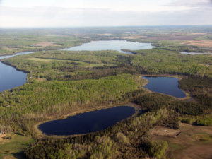 Photo Credit: Robert Holmberg, Repository of the Athabasca River Basin, Athabasca University. Areal photo of Baptiste Lake.